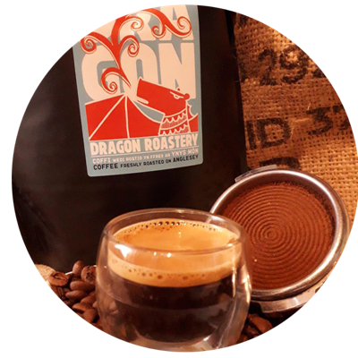 Espresso in front of a bag of Dragon Roastery coffee